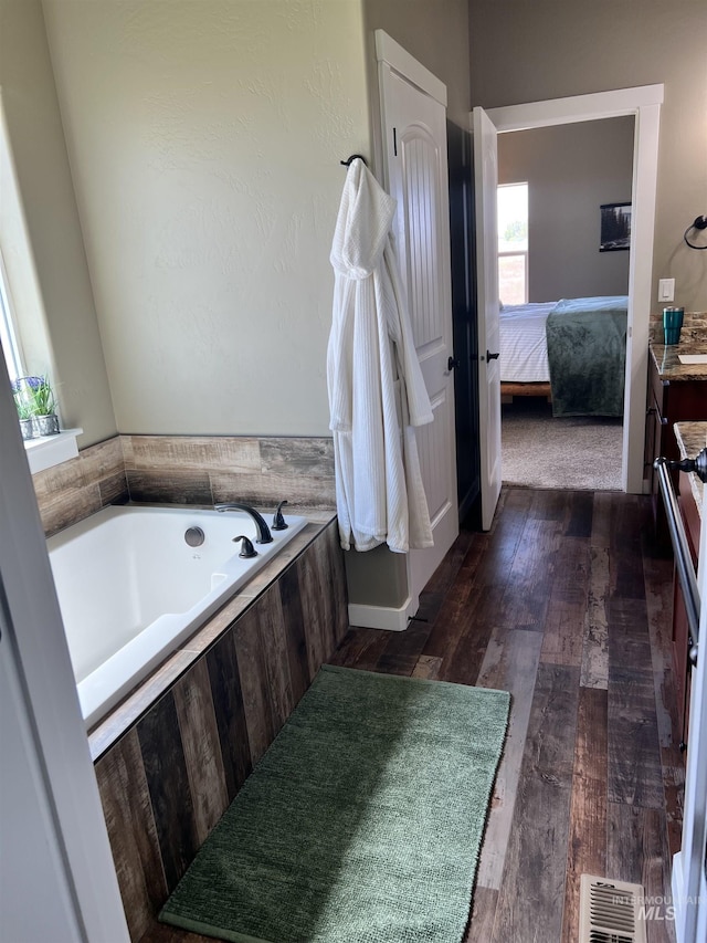 628 Pioneer Mountain Loop, Jerome, ID 83338 - full bathroom with a bath, ensuite bathroom, vanity, and wood finished floors