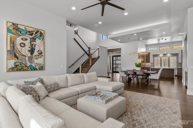 living room featuring recessed lighting, a high ceiling, a ceiling fan, wood finished floors, and stairs