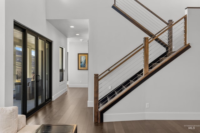 foyer entrance featuring dark wood-type flooring, recessed lighting, baseboards, and stairs