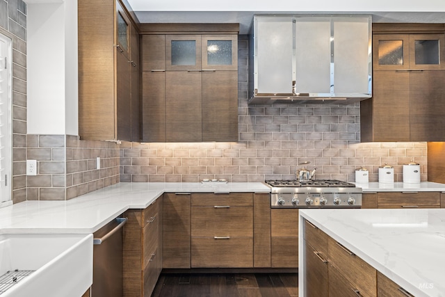 kitchen featuring tasteful backsplash, brown cabinetry, and stainless steel gas stovetop