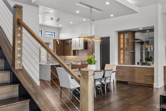 dining space with dark wood-style floors, stairway, and recessed lighting