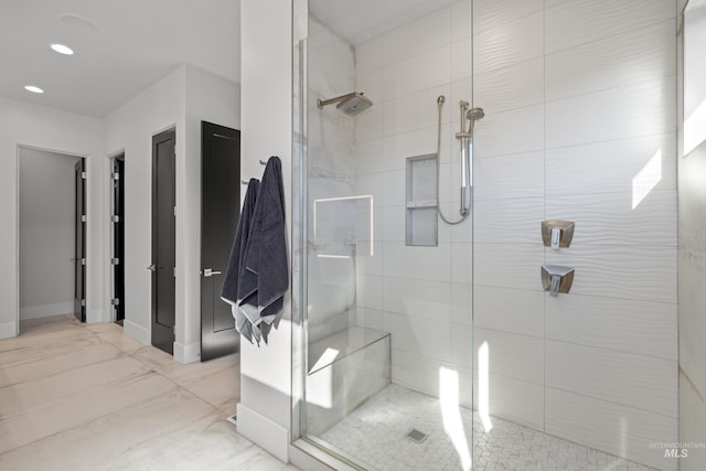 bathroom featuring marble finish floor, recessed lighting, a shower stall, and baseboards