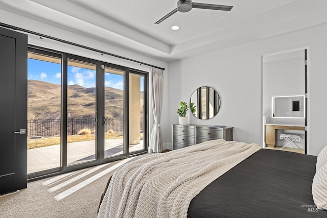 carpeted bedroom featuring a mountain view, recessed lighting, a ceiling fan, access to exterior, and ensuite bath