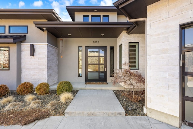 entrance to property with stucco siding