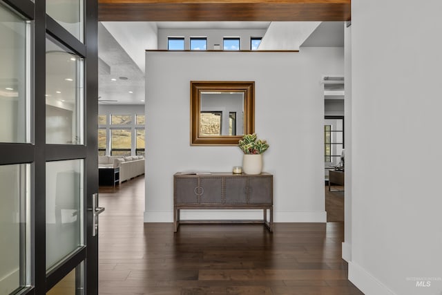 hall with baseboards and hardwood / wood-style floors