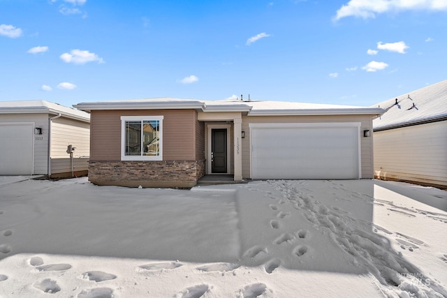 view of front of house featuring an attached garage and stone siding