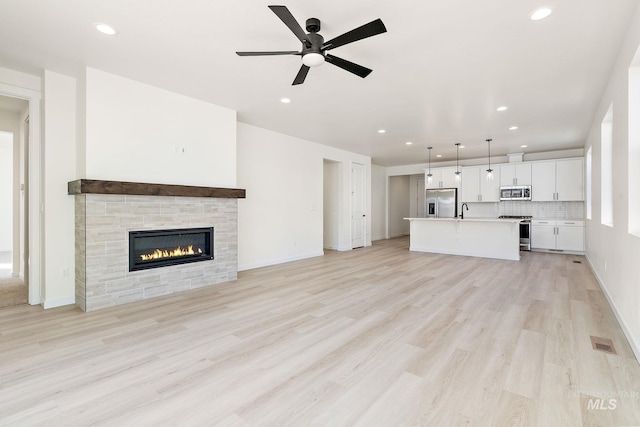 unfurnished living room featuring recessed lighting, visible vents, and light wood-style floors