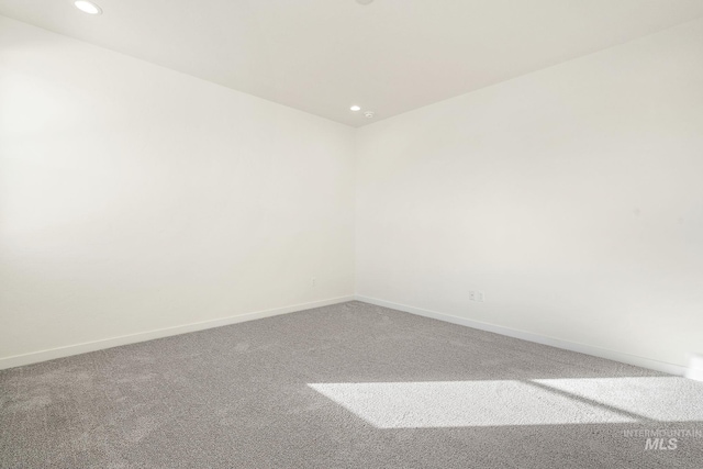 carpeted spare room with recessed lighting and baseboards