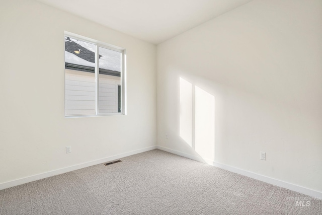 carpeted empty room with visible vents and baseboards