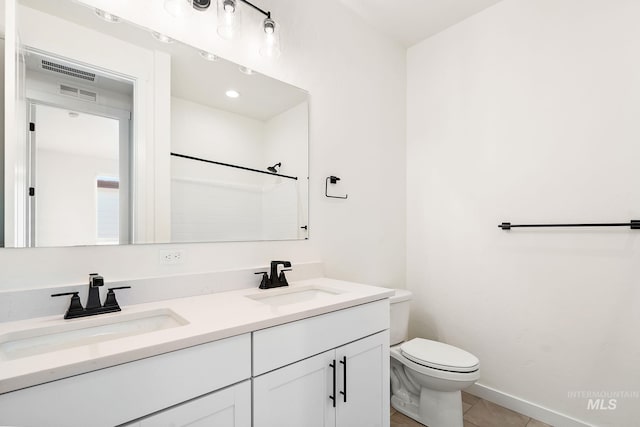 full bathroom featuring tile patterned floors, a sink, toilet, and double vanity