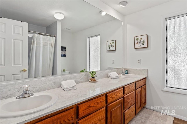 3752 Lancer Way, Boise, ID 83713 - full bathroom with double vanity, healthy amount of natural light, toilet, and a shower with curtain