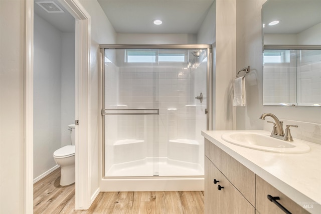 4913 Endicott Dr, Caldwell, ID 83605 - full bath with a stall shower, vanity, wood finished floors, and recessed lighting