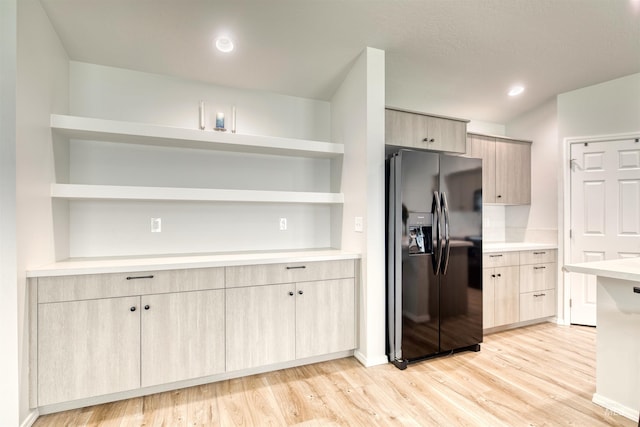 4913 Endicott Dr, Caldwell, ID 83605 - kitchen featuring black fridge with ice dispenser, open shelves, and light brown cabinets