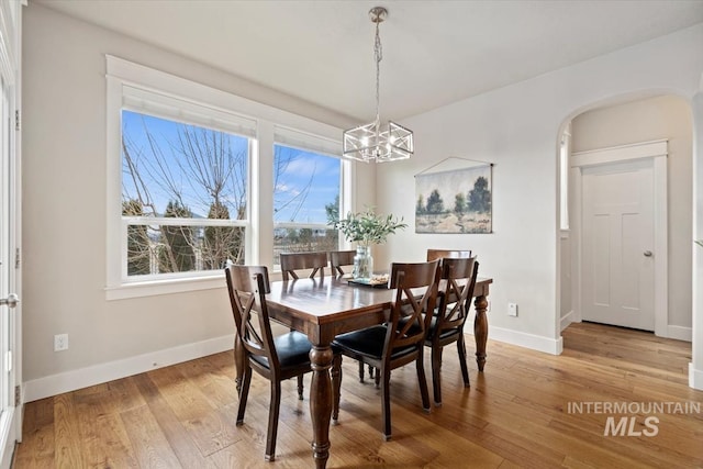 dining room featuring a notable chandelier and light hardwood / wood-style floors