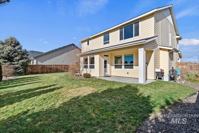 rear view of house featuring a patio area and a lawn