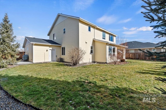 back of house with a lawn and central air condition unit