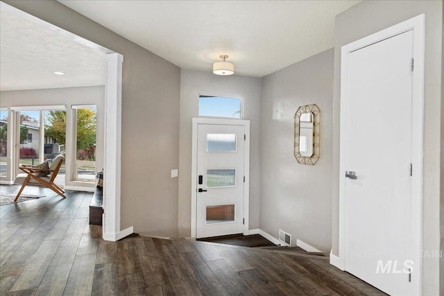 entryway featuring a textured ceiling and dark hardwood / wood-style flooring