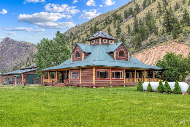 log home featuring a mountain view and a front lawn