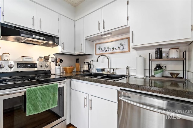 kitchen with under cabinet range hood, a sink, white cabinetry, appliances with stainless steel finishes, and dark countertops