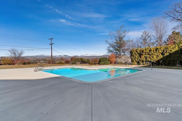 view of swimming pool with a fenced in pool and a patio area