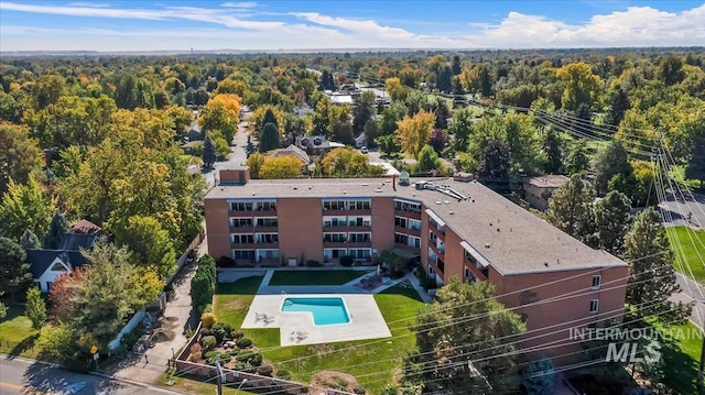 drone / aerial view featuring a forest view