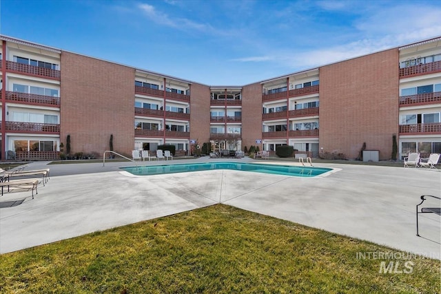 community pool with a patio area