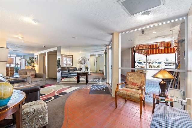 tiled living room featuring visible vents and a textured ceiling