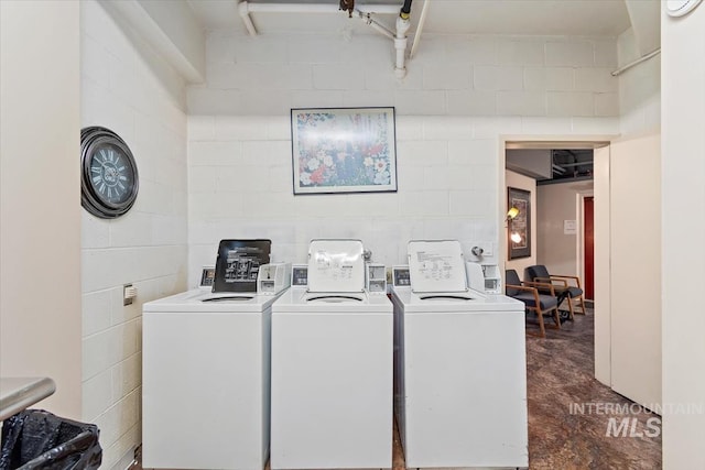 community laundry room featuring washing machine and clothes dryer