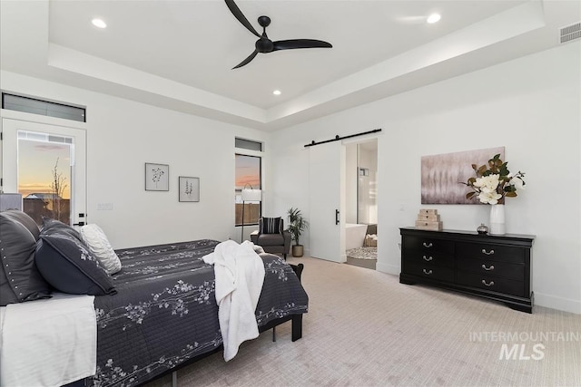 9891 W Napier Ct, Star, ID 83669 - carpeted bedroom featuring a raised ceiling, a barn door, recessed lighting, ensuite bathroom, and ceiling fan