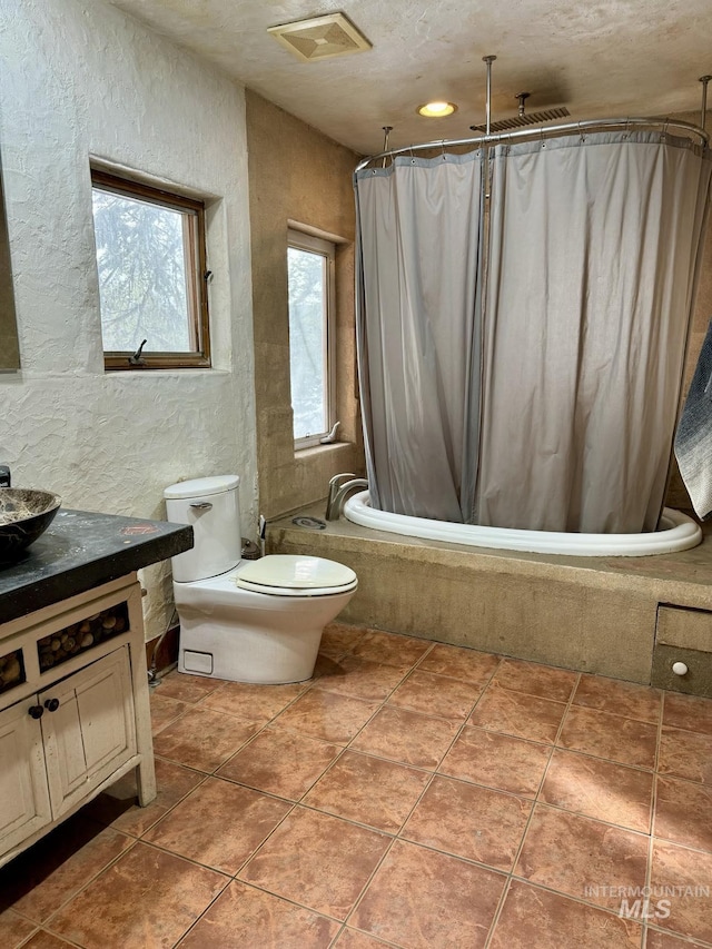 full bathroom featuring shower / bath combination with curtain, tile patterned floors, toilet, and vanity