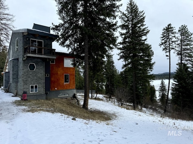 view of snowy exterior featuring a balcony