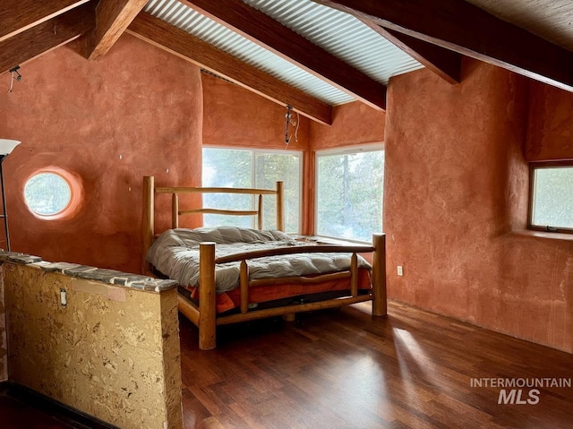 bedroom with vaulted ceiling with beams and dark wood-type flooring