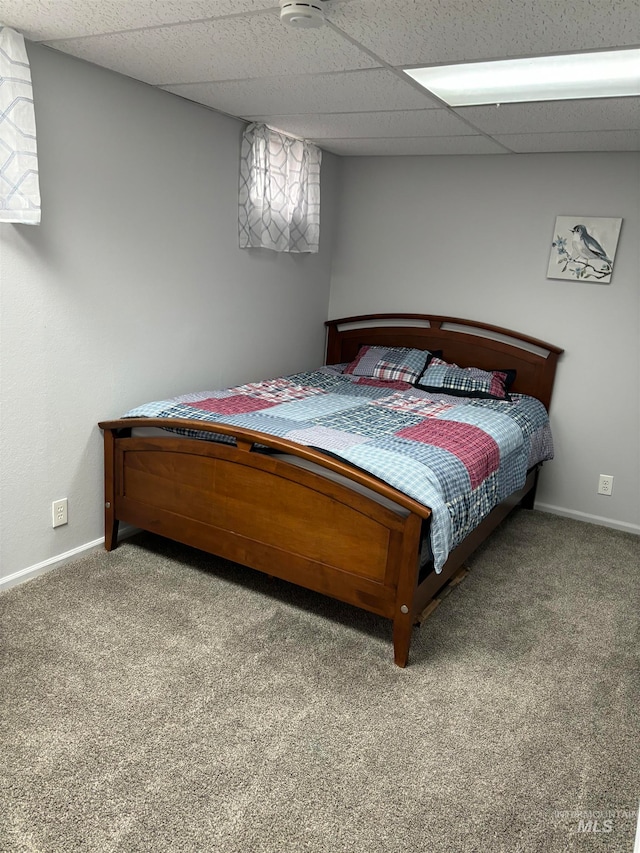 bedroom featuring carpet flooring and a paneled ceiling