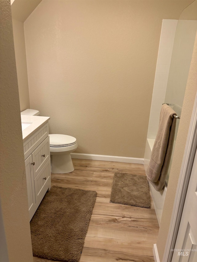 bathroom featuring hardwood / wood-style floors, vanity, and toilet