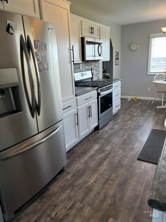 kitchen with decorative backsplash, stainless steel appliances, white cabinetry, and dark wood-type flooring