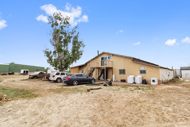 27410 Peckham Rd, Wilder, ID 83676 - exterior space featuring stucco siding, a wooden deck, and stairs