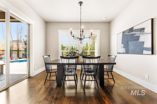 3061 S Fox Run Ave, Eagle, ID 83616 - dining room with a chandelier, dark wood-style floors, and baseboards