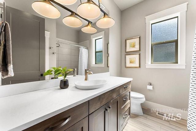3061 S Fox Run Ave, Eagle, ID 83616 - full bathroom featuring toilet, vanity, baseboards, a shower with curtain, and wood finished floors