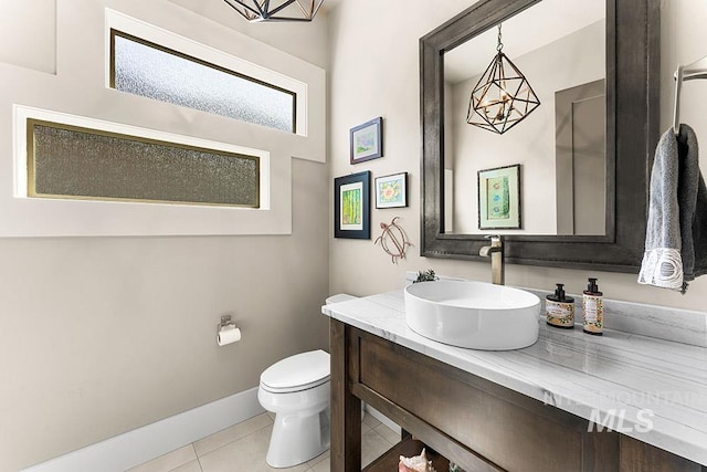 3061 S Fox Run Ave, Eagle, ID 83616 - bathroom with tile patterned floors, vanity, toilet, and baseboards