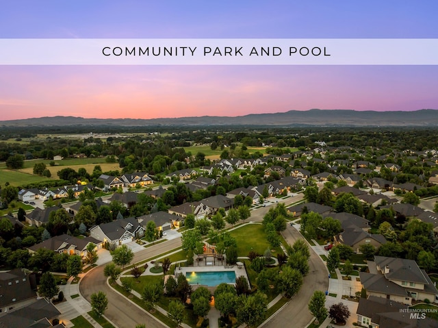 3061 S Fox Run Ave, Eagle, ID 83616 - aerial view at dusk of a mountain view, view of pool area, and a residential view