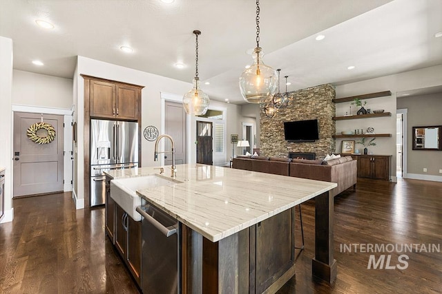 3061 S Fox Run Ave, Eagle, ID 83616 - kitchen featuring stainless steel appliances, a sink, recessed lighting, dark wood-style floors, and light stone countertops