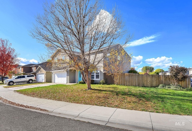 view of front of home featuring a front yard and a garage