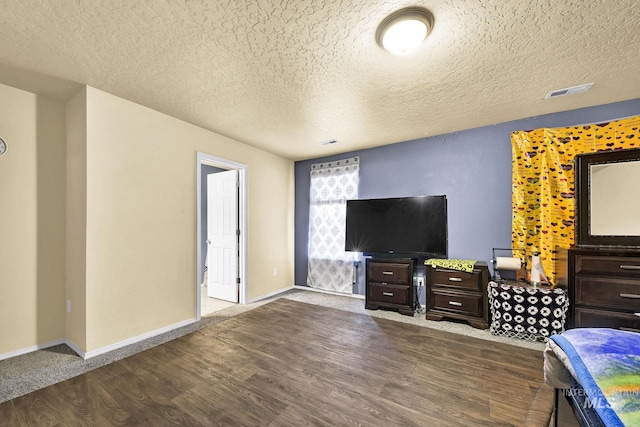 unfurnished bedroom featuring wood-type flooring and a textured ceiling