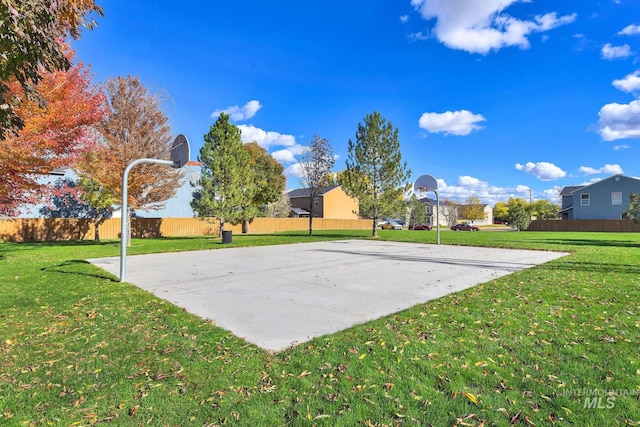 view of basketball court featuring a lawn