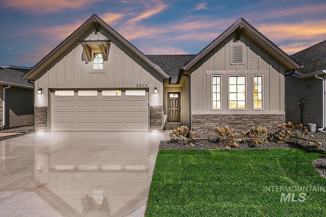 view of front of home with a garage and a yard