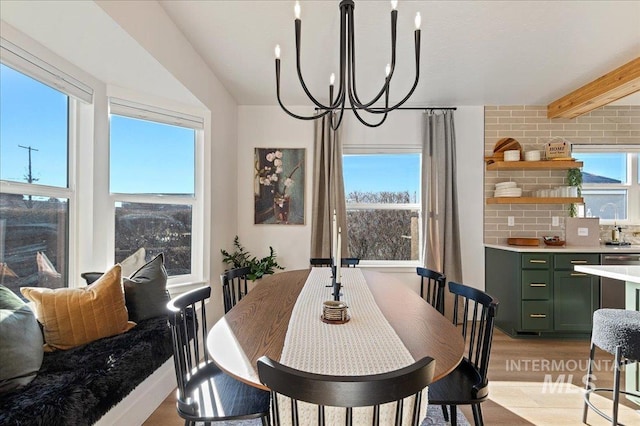 dining room featuring an inviting chandelier and beam ceiling