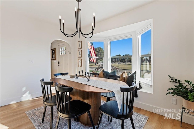 dining space featuring hardwood / wood-style floors and a notable chandelier