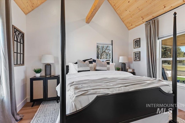 bedroom featuring beam ceiling, hardwood / wood-style floors, wood ceiling, and high vaulted ceiling