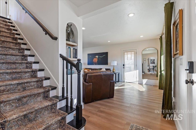 stairs featuring hardwood / wood-style floors