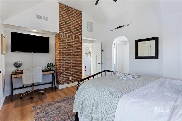 bedroom featuring wood-type flooring, ceiling fan, and high vaulted ceiling